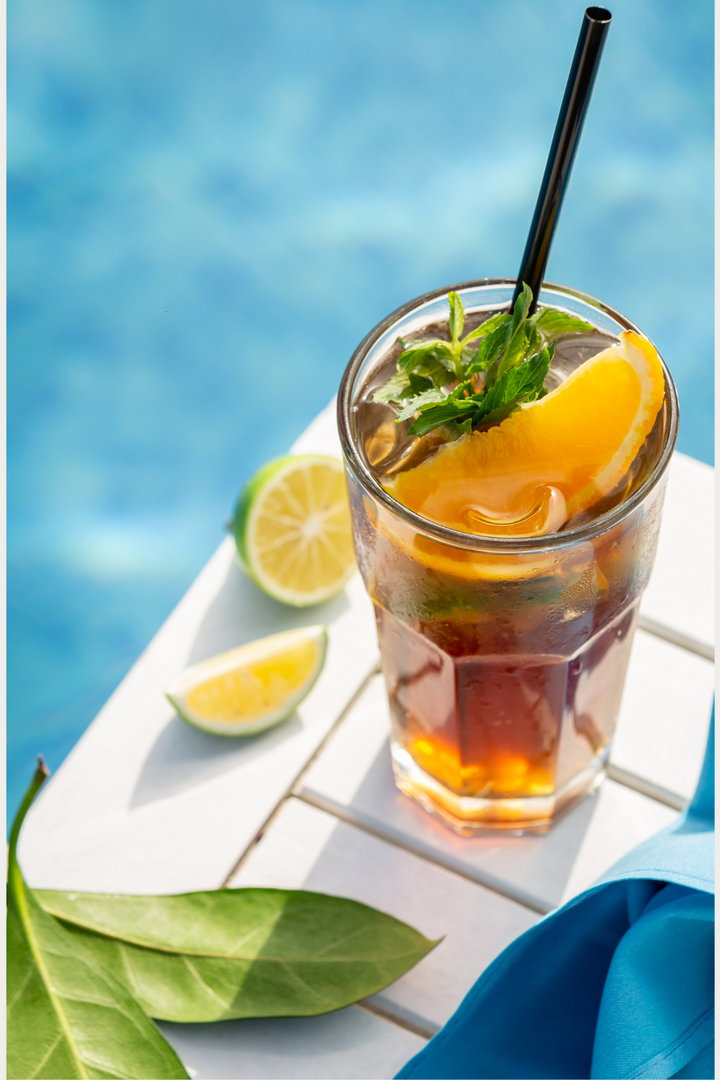 cup of iced brewed tea sitting next to a pool