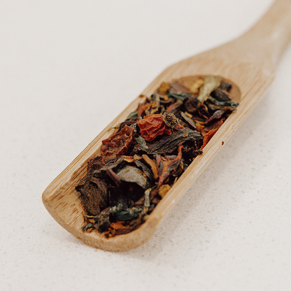 IngenuiTea™ Hibiscus Sunrise bright red herbal tea on spoon